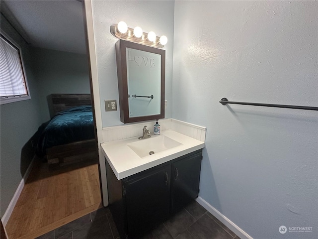 bathroom featuring tile patterned flooring and vanity