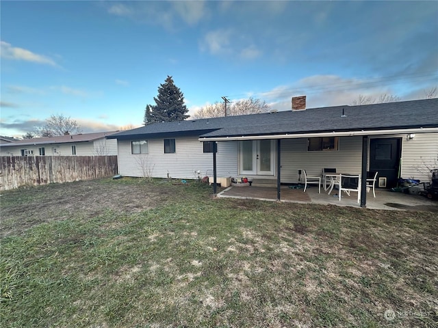 rear view of house with a yard and a patio area