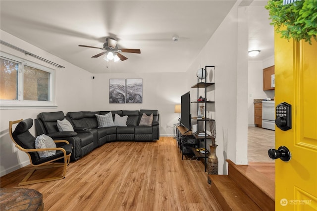 living room with light hardwood / wood-style floors and ceiling fan