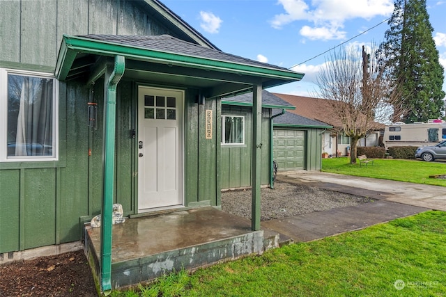 property entrance with a garage and a yard