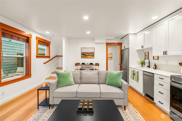 living room featuring light hardwood / wood-style flooring and sink