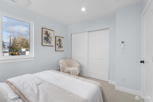 bedroom featuring a closet and light colored carpet