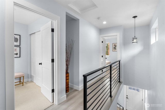 hallway with light hardwood / wood-style floors and plenty of natural light