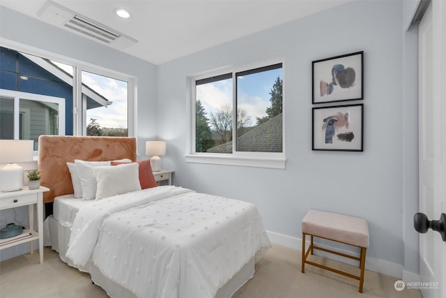 carpeted bedroom featuring multiple windows