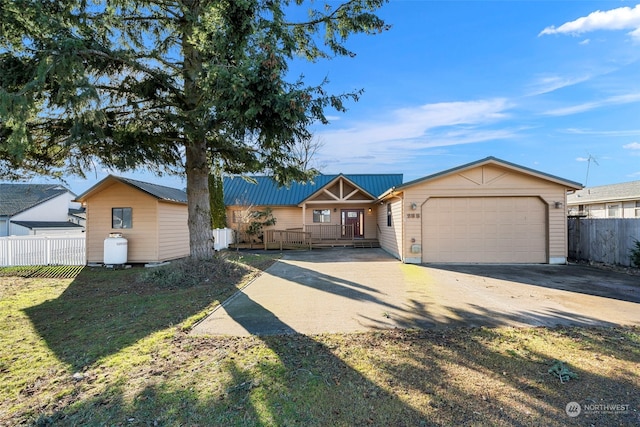 ranch-style house featuring a front yard, a garage, and an outbuilding