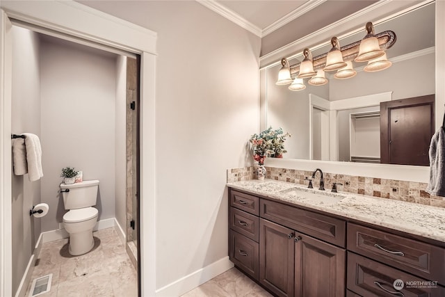 bathroom featuring vanity, crown molding, and toilet