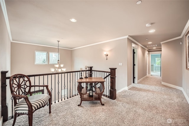 hall with crown molding, plenty of natural light, light carpet, and a chandelier