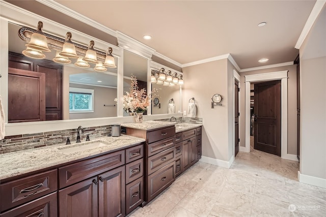 full bath with crown molding, double vanity, tasteful backsplash, a sink, and baseboards