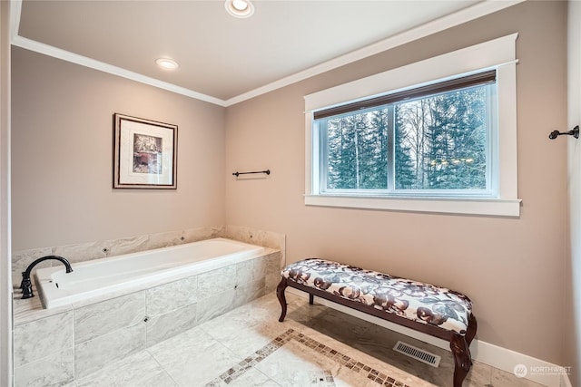 bathroom featuring a relaxing tiled tub and ornamental molding