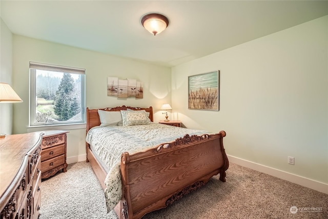 bedroom with light carpet and baseboards