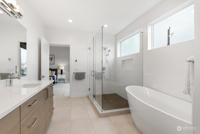 bathroom featuring vanity, plus walk in shower, and tile patterned flooring