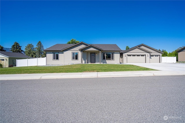 ranch-style home with a front lawn and a garage