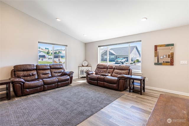 living room featuring vaulted ceiling and light hardwood / wood-style floors