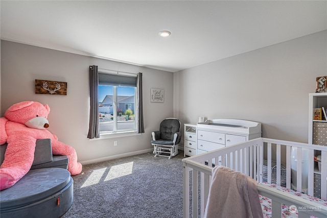 bedroom with a crib and dark carpet