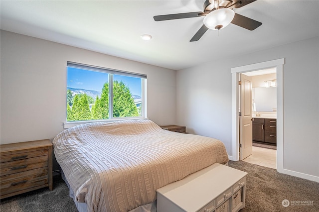 carpeted bedroom featuring ceiling fan and connected bathroom