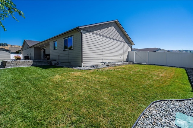 view of home's exterior with a yard