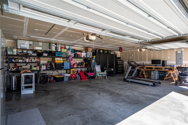 garage with a garage door opener and electric panel