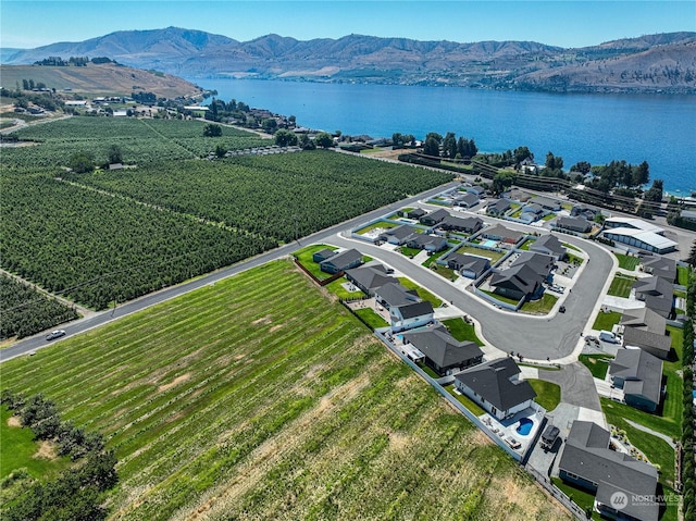 drone / aerial view featuring a water and mountain view