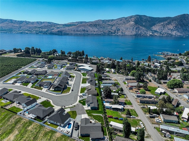 drone / aerial view with a water and mountain view