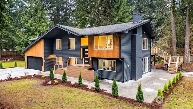 view of front of home with a garage and a front lawn