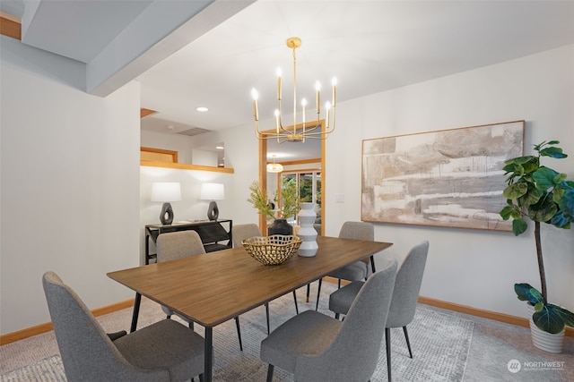 dining room featuring carpet and a notable chandelier