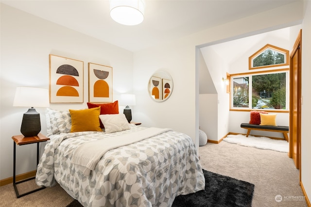 bedroom with lofted ceiling and carpet flooring