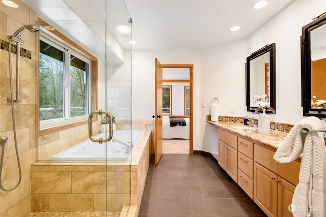 bathroom with vanity, tile patterned floors, and plus walk in shower