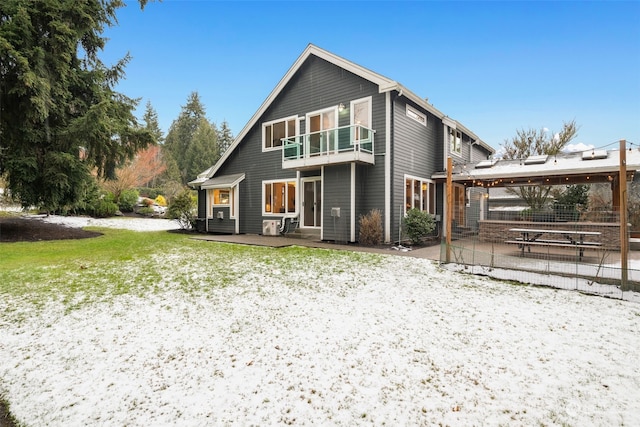 back of house with a balcony and a patio area