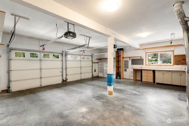 garage with a garage door opener and electric panel