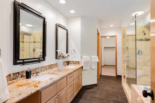 bathroom featuring walk in shower, tile patterned floors, vanity, and backsplash