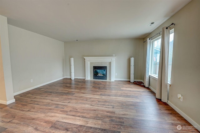 unfurnished living room featuring hardwood / wood-style floors and a fireplace