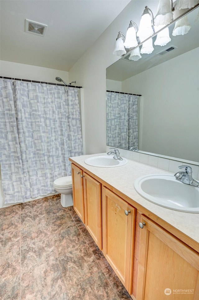 bathroom featuring vanity, toilet, and a shower with shower curtain