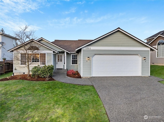 ranch-style house featuring a front lawn and a garage