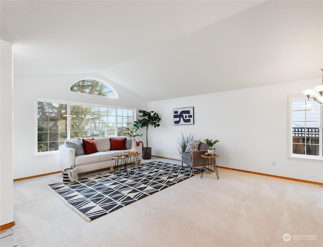 carpeted living room with lofted ceiling, an inviting chandelier, and a healthy amount of sunlight