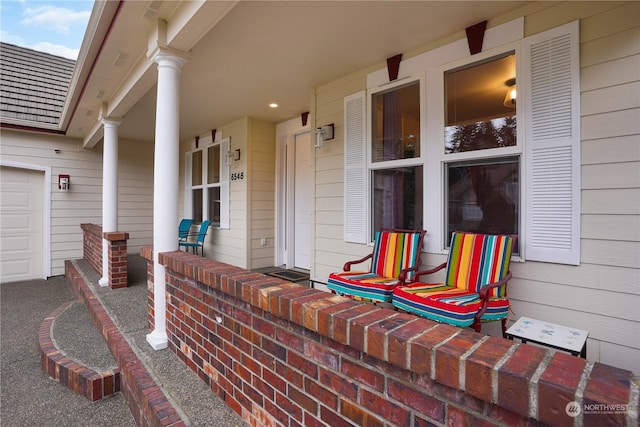 view of patio with covered porch and a garage