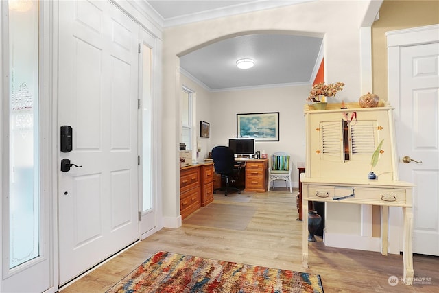 entryway featuring ornamental molding and light hardwood / wood-style floors