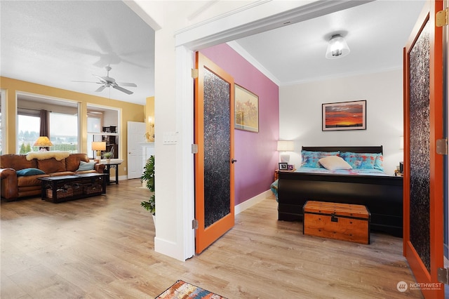 bedroom with ceiling fan, ornamental molding, and light wood-type flooring