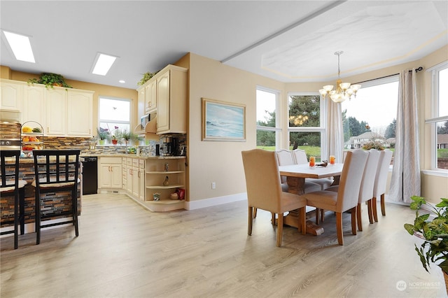 dining area featuring a notable chandelier and light hardwood / wood-style flooring