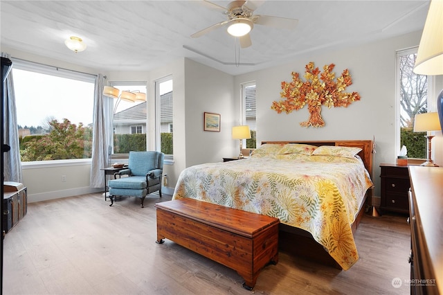 bedroom with ceiling fan and light hardwood / wood-style flooring