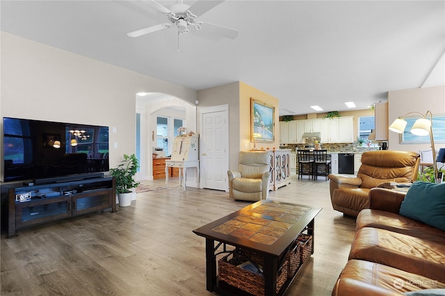 living room with ceiling fan and light wood-type flooring