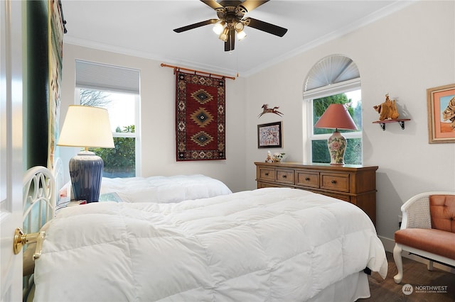 bedroom with ceiling fan, wood-type flooring, and crown molding