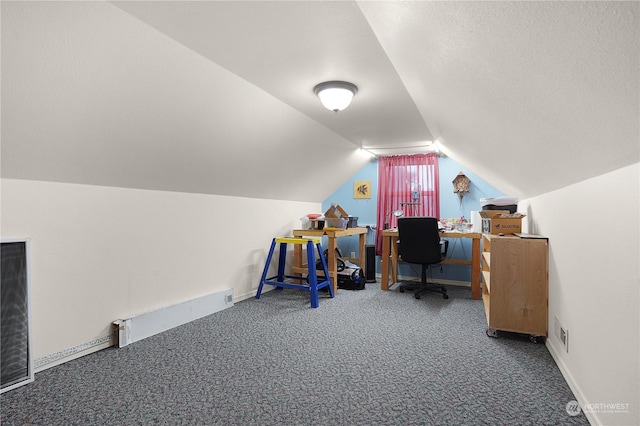 office featuring baseboard heating, carpet, and lofted ceiling