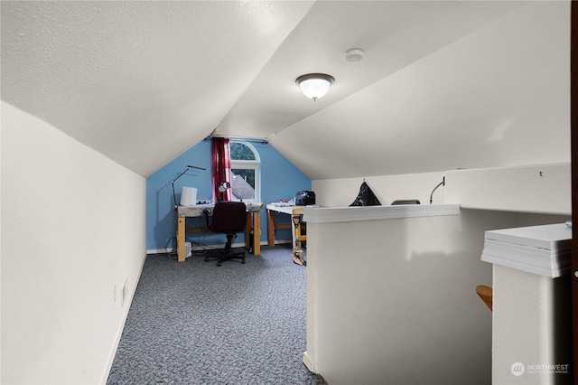 carpeted office with vaulted ceiling and a textured ceiling