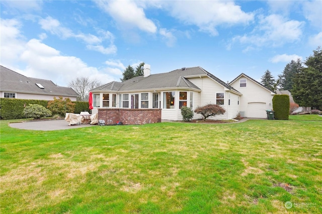 rear view of house featuring a patio area and a yard