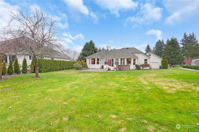 view of front of house with a patio area and a front lawn