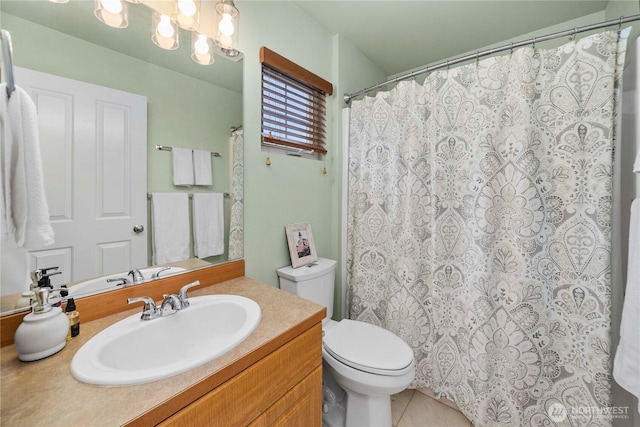 bathroom featuring tile patterned floors, toilet, vanity, and an inviting chandelier