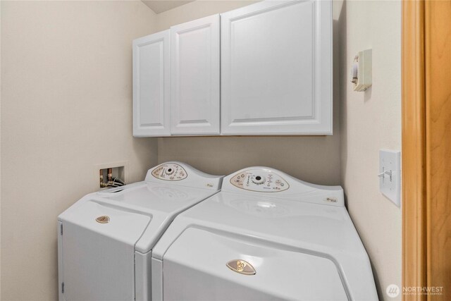 laundry room with washer and clothes dryer and cabinet space