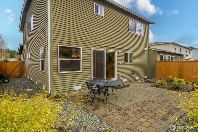 back of property featuring a patio, fence, and crawl space