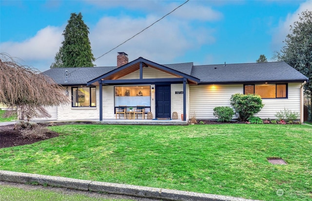 view of front of property featuring a front lawn and a patio