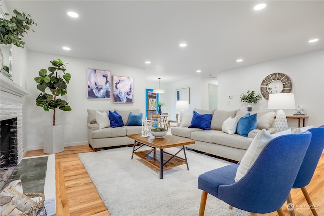 living room with hardwood / wood-style flooring and a tile fireplace